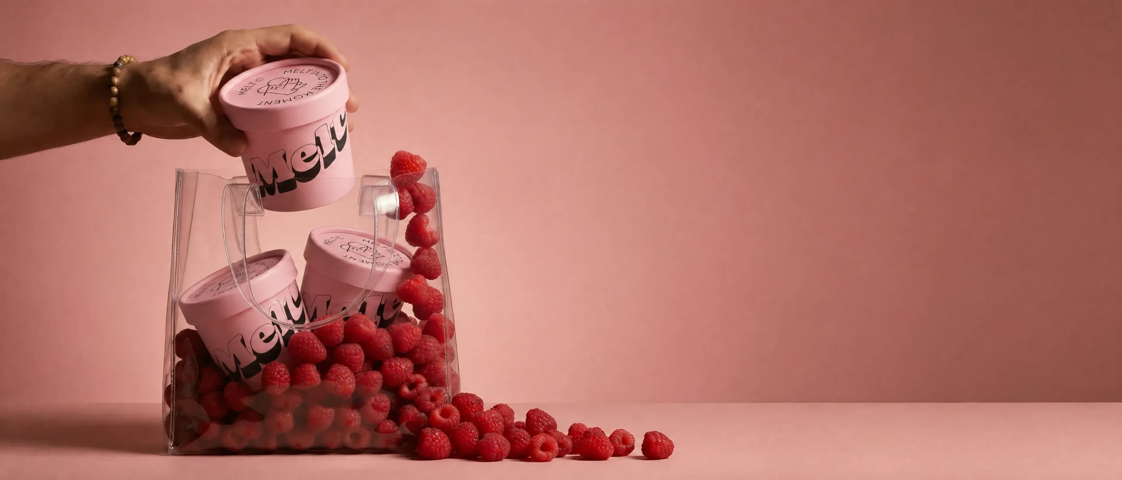 Dessert product still — pink cups with fresh raspberries