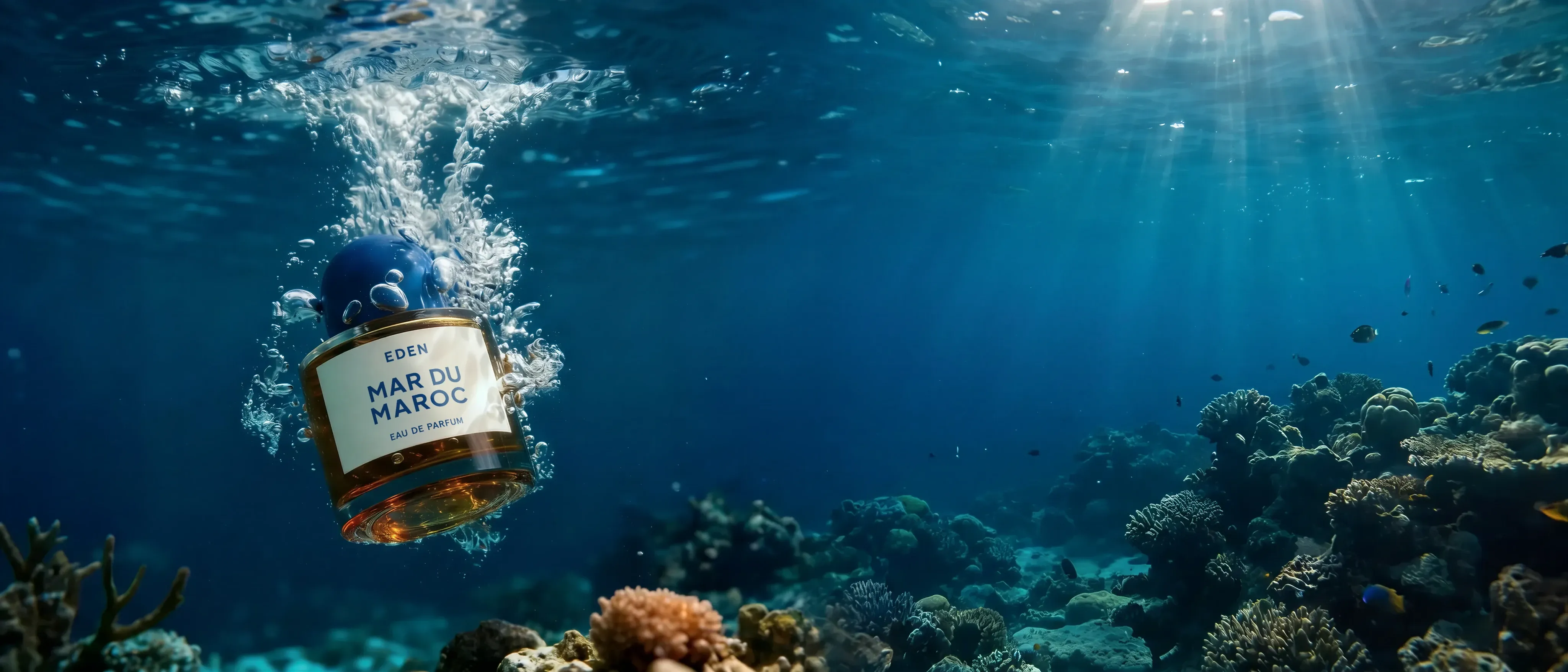 Fragrance hero — a perfume bottle photographed underwater